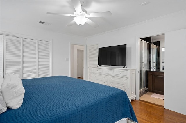 bedroom with ceiling fan, wood-type flooring, and a closet