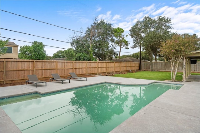 view of swimming pool featuring a lawn and a patio