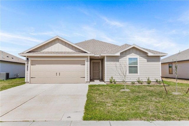 single story home with concrete driveway, board and batten siding, central AC, a garage, and a front lawn