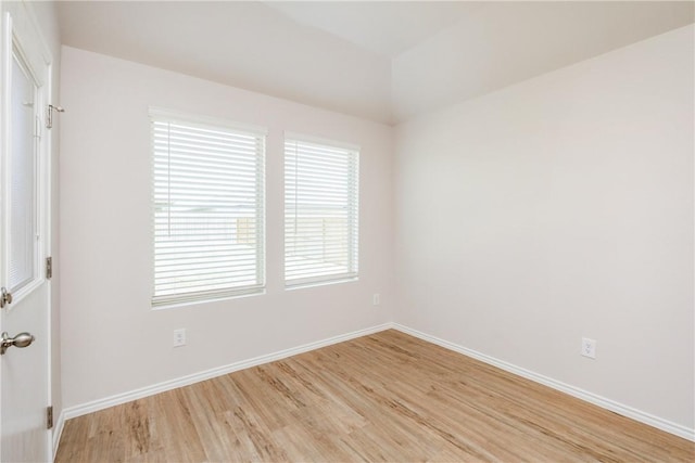 unfurnished room with light wood-style floors and baseboards