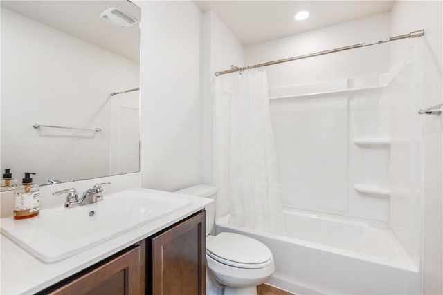 full bathroom with visible vents, shower / bath combo, vanity, and toilet