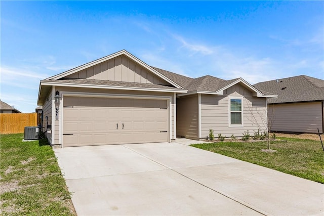 ranch-style home with concrete driveway, an attached garage, fence, central AC, and a front yard