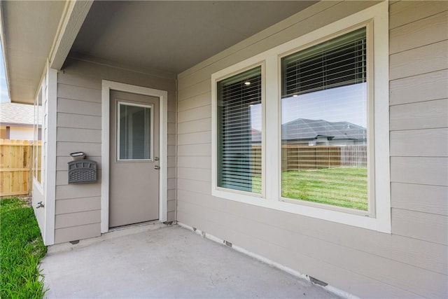 doorway to property with fence