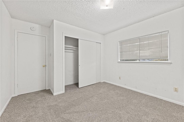 7006 Powderhorn Ct, Corpus Christi, TX 78413 - unfurnished bedroom featuring a textured ceiling, carpet, and a closet