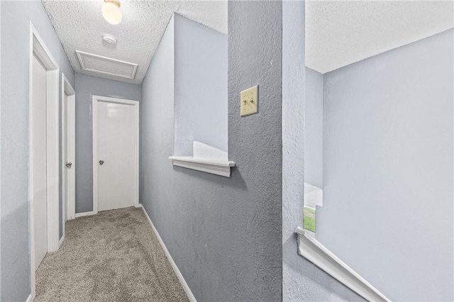 7006 Powderhorn Ct, Corpus Christi, TX 78413 - hall featuring a textured ceiling, carpet flooring, attic access, and a textured wall