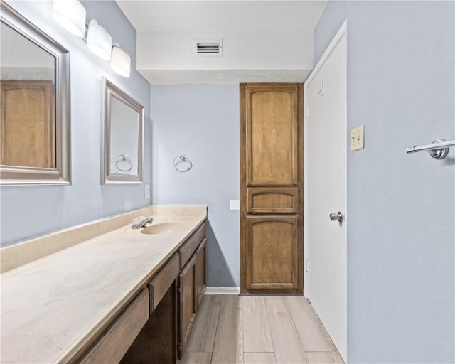 bathroom featuring hardwood / wood-style floors and vanity