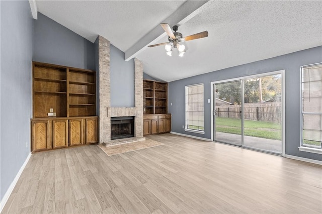 7006 Powderhorn Ct, Corpus Christi, TX 78413 - unfurnished living room featuring lofted ceiling, a fireplace, light wood-type flooring, a ceiling fan, and a textured ceiling