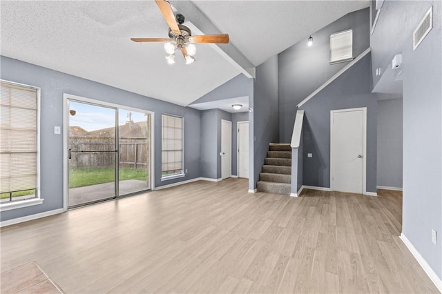 7006 Powderhorn Ct, Corpus Christi, TX 78413 - unfurnished living room with wood finished floors, stairway, ceiling fan, plenty of natural light, and beam ceiling