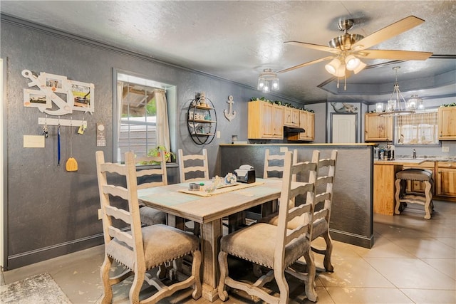 dining space with crown molding, a textured wall, a ceiling fan, and a textured ceiling