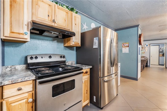 kitchen with under cabinet range hood, stainless steel appliances, light brown cabinetry, and light tile patterned floors