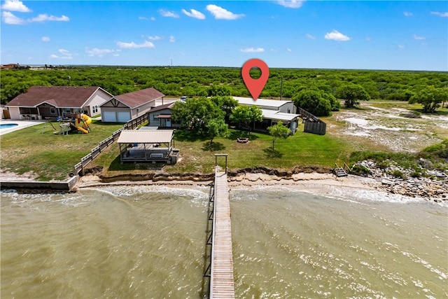drone / aerial view with a water view and a view of trees
