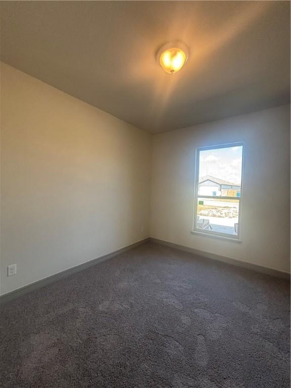 106 Guadalupe Palm Cir, Portland, TX 78374 - spare room featuring dark carpet and baseboards