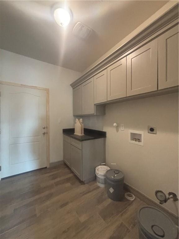 106 Guadalupe Palm Cir, Portland, TX 78374 - laundry room with washer hookup, cabinet space, electric dryer hookup, wood finished floors, and hookup for a gas dryer