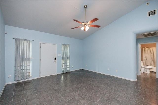 spare room featuring vaulted ceiling and ceiling fan