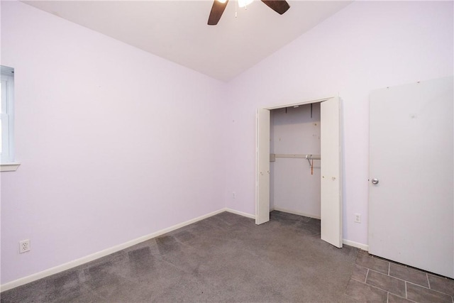 unfurnished bedroom featuring ceiling fan, lofted ceiling, and dark carpet