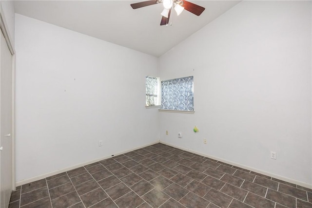 empty room with ceiling fan and vaulted ceiling