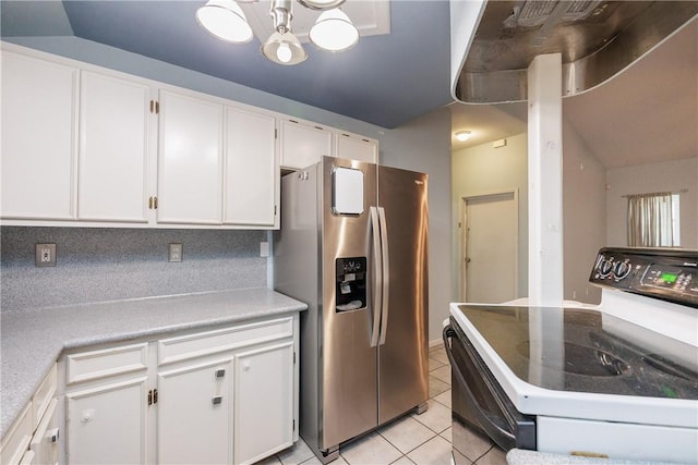 kitchen with stainless steel fridge with ice dispenser, light tile patterned floors, white cabinetry, electric stove, and vaulted ceiling