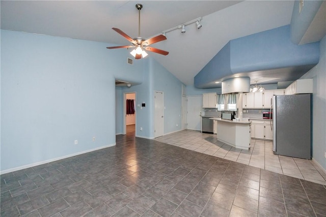 kitchen featuring ceiling fan, a center island, stainless steel appliances, high vaulted ceiling, and white cabinets