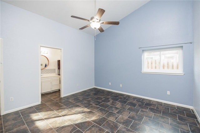 unfurnished bedroom with lofted ceiling, ensuite bath, and ceiling fan