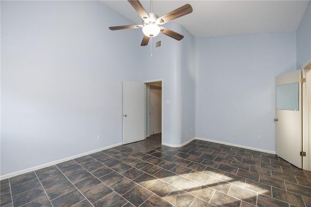 empty room featuring ceiling fan and high vaulted ceiling