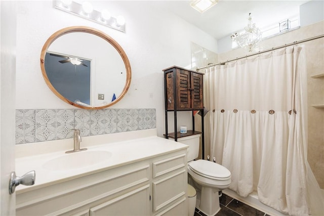 bathroom featuring toilet, vanity, tile patterned flooring, and walk in shower