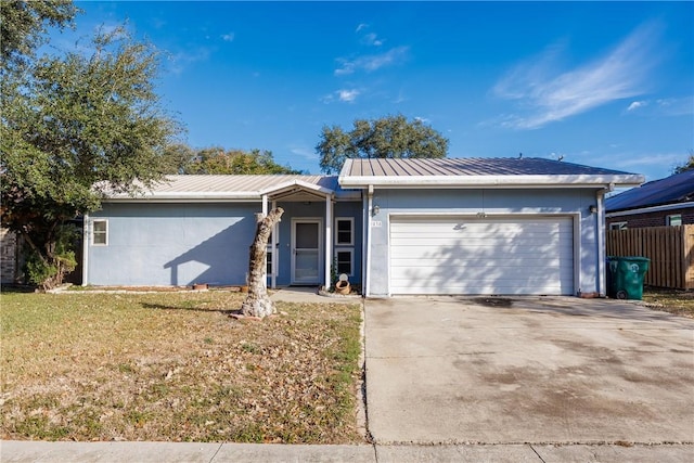 ranch-style home with a front lawn and a garage