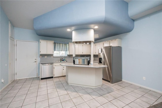 kitchen featuring a center island, decorative backsplash, light tile patterned flooring, white cabinetry, and stainless steel appliances