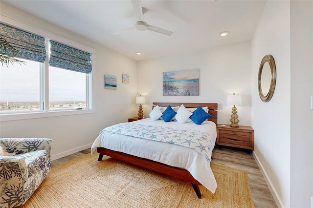 bedroom featuring ceiling fan and light hardwood / wood-style flooring