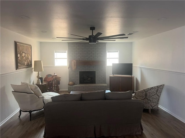 3023 66th St, Lubbock, TX 79413 - living area featuring wainscoting, ceiling fan, wood finished floors, a fireplace, and baseboards