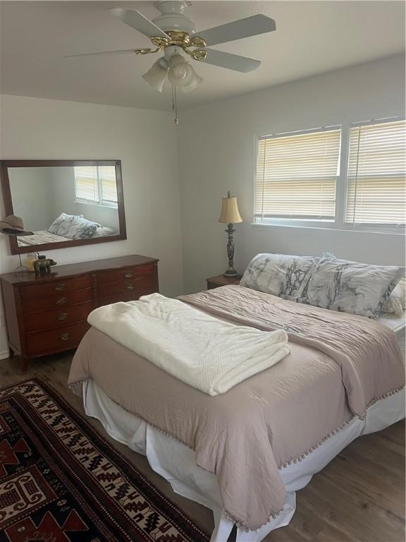 3023 66th St, Lubbock, TX 79413 - bedroom featuring dark wood-style flooring and a ceiling fan