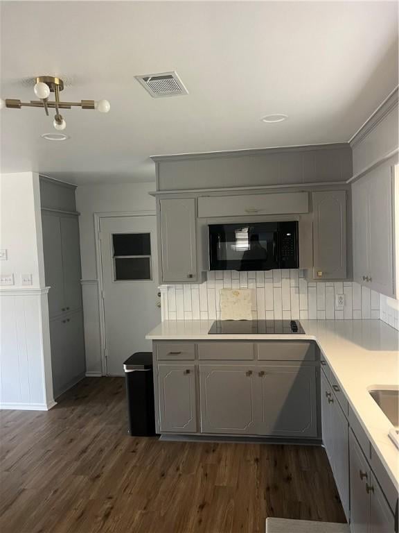 3023 66th St, Lubbock, TX 79413 - kitchen featuring black appliances, gray cabinetry, light countertops, and dark wood-type flooring