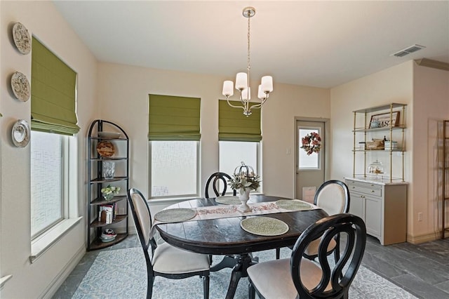 dining space featuring an inviting chandelier