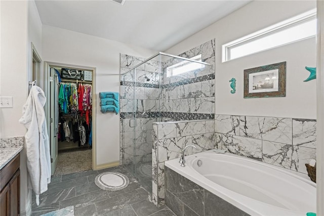 bathroom with vanity and independent shower and bath