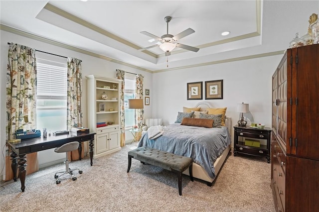 bedroom with light carpet, ornamental molding, a raised ceiling, and ceiling fan