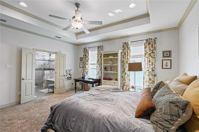 carpeted bedroom featuring crown molding, ceiling fan, ensuite bathroom, and a tray ceiling