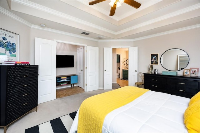 bedroom featuring a raised ceiling, ceiling fan, light colored carpet, and crown molding