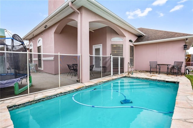 view of pool featuring a patio area and a trampoline