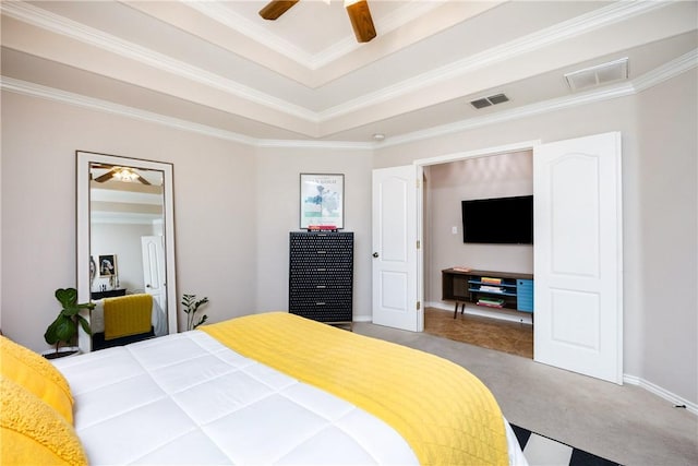 bedroom with carpet flooring, a raised ceiling, ceiling fan, and ornamental molding