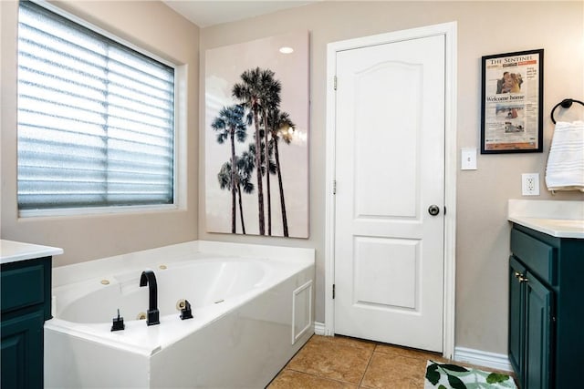 bathroom with a bathtub, tile patterned flooring, and vanity