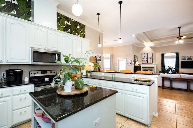 kitchen featuring white cabinets, a center island, appliances with stainless steel finishes, and pendant lighting