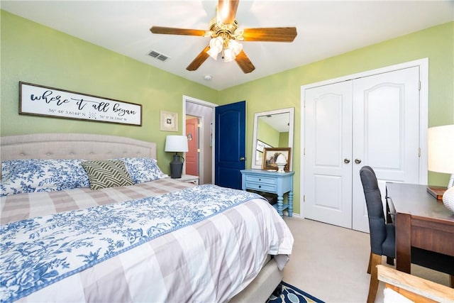 bedroom featuring ceiling fan, a closet, and light carpet