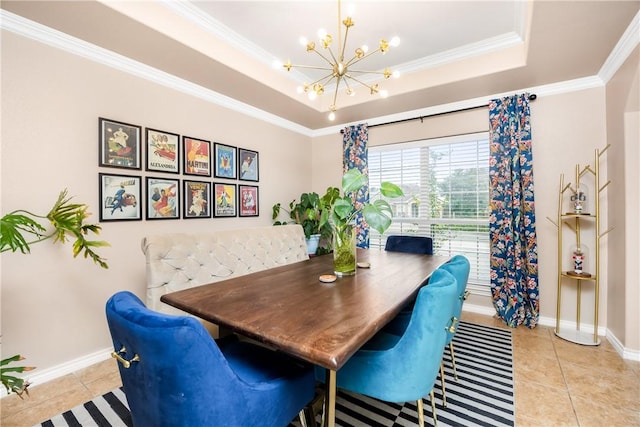 tiled dining area featuring a tray ceiling, ornamental molding, and an inviting chandelier