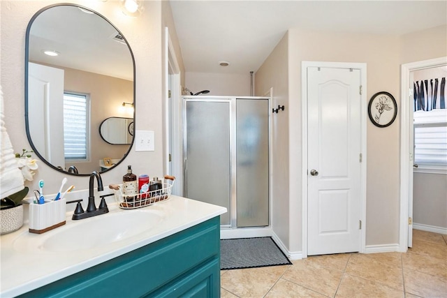 bathroom with tile patterned floors, a shower with door, and vanity