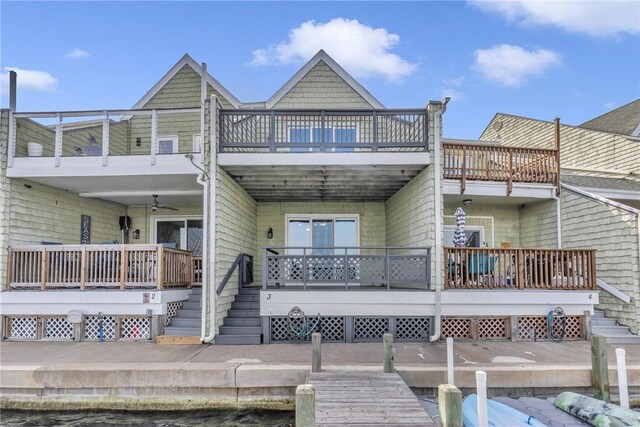 rear view of property featuring stairs, a deck, a balcony, and ceiling fan