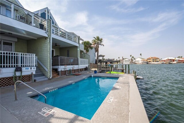 pool featuring a boat dock and a water view