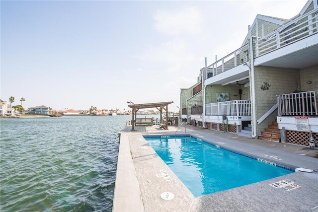 community pool featuring a patio area and a water view