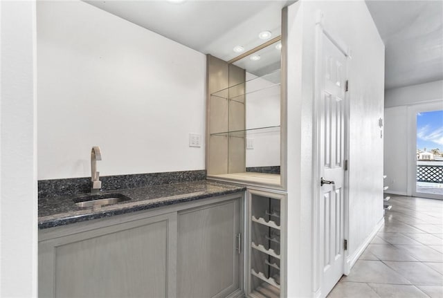 interior space with vanity, baseboards, recessed lighting, tile patterned floors, and toilet