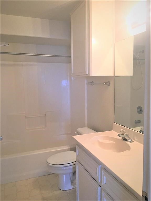 full bathroom featuring vanity, washtub / shower combination, and toilet