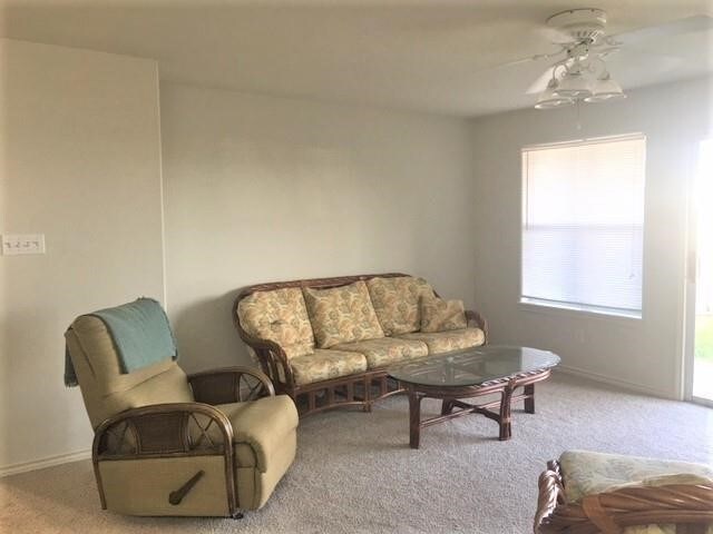 living room with carpet flooring and ceiling fan