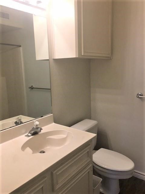 bathroom featuring toilet and vanity